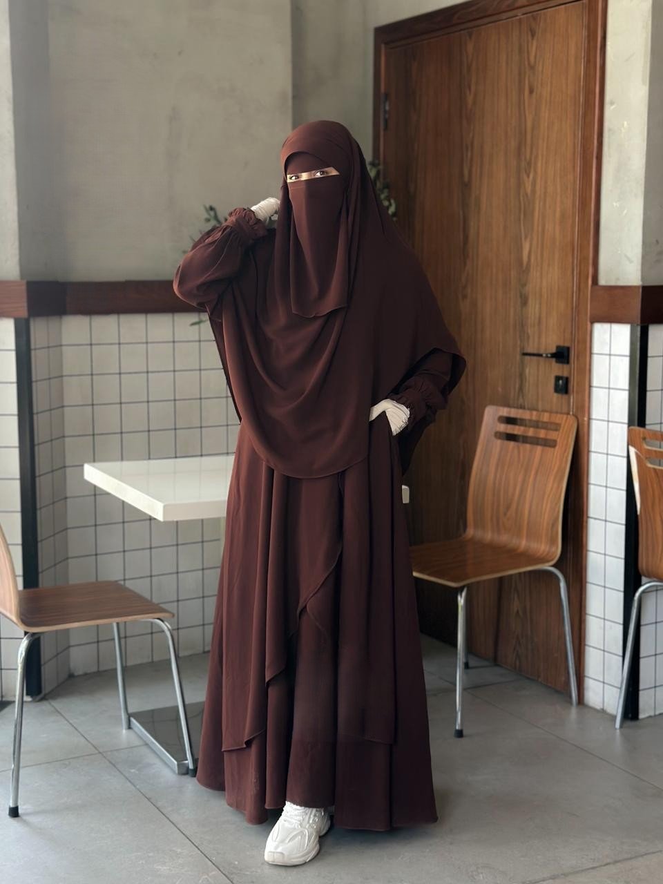 Front view of the Fereha brown set highlighting the ruffled sleeves and elegant silhouette.